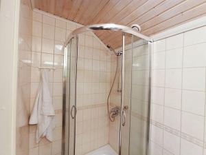 a shower with a glass door in a bathroom at Cosy Loft in Helsinki
