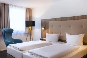 ACHAT Hotel Stuttgart Zuffenhausen 객실 침대