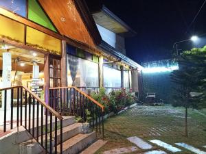a house with a staircase outside at night at Infinite Green Pension in Puerto Princesa City