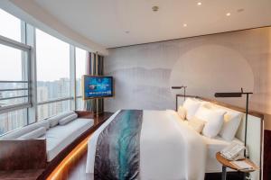 Posteľ alebo postele v izbe v ubytovaní New Century Hotel Qianchao Hangzhou