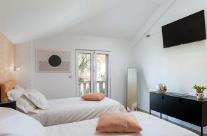 1 dormitorio con 2 camas y TV de pantalla plana en Apartments Subrenum, en Mlini