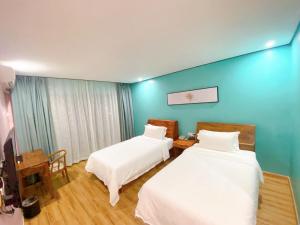 Postel nebo postele na pokoji v ubytování Junlan Hotel