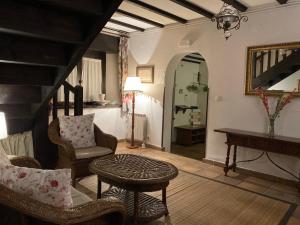 a living room with a table and chairs and a piano at Posada Mellante in Pechón