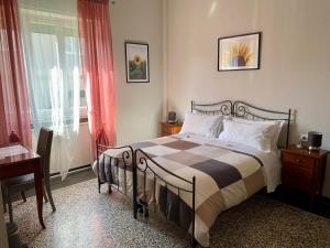 a bedroom with a bed and a dresser at Villa Catelli B&B in Lucca