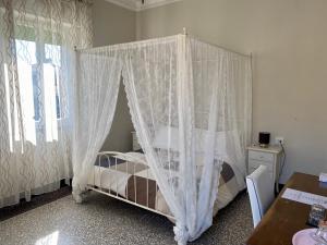 a bed that has a canopy over it at Villa Catelli B&B in Lucca