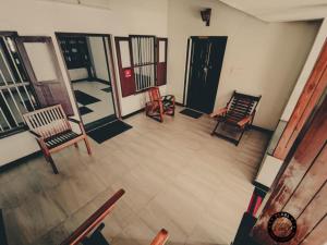 an overhead view of a living room with chairs at Pearl Beach Bungalow in Alleppey