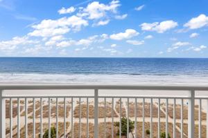 a view of the beach from the balcony of a condo at Breathtaking Oceanfront Views - Atlantica Towers Condo in Myrtle Beach