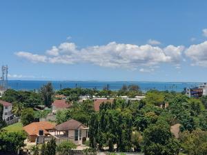 a view of a town with houses and the ocean at The Penthouse oysterbay in Dar es Salaam