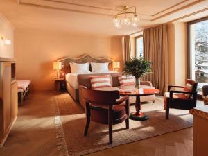 a hotel room with a bed and a table at BEAUSiTE Zermatt in Zermatt
