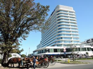 a horse drawn carriage in front of a tall building at Apartment in Swinoujscie near Baltic Beach in Świnoujście