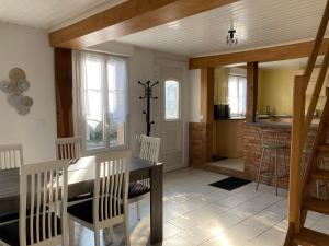 a kitchen and dining room with a table and chairs at L'Aube en Somme in Millencourt-en-Ponthieu