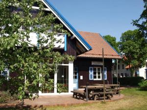 a building with a picnic table in front of it at Aika in Nida