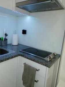 a kitchen with a stove top oven on a counter at Home Beach in Figueira da Foz