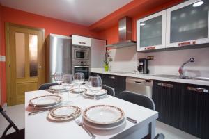 a kitchen with a table with wine glasses on it at Casa Goros in Melide