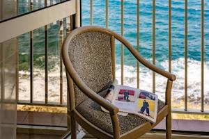 a chair with a book and a toothbrush in it at The Diplomat Hotel in Sliema