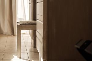 a stool sitting next to a dresser in a kitchen at The Diplomat Hotel in Sliema