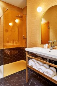 a bathroom with a sink and a shower at Hotel De Cambis in Avignon