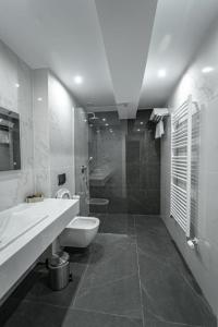 a bathroom with a sink and a toilet and a shower at Caprice Complex in Bacău