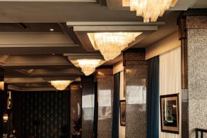 a row of chandeliers hanging from the ceiling of a lobby at The Diplomat Hotel in Sliema