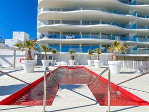 una piscina di fronte a un edificio di AMAZING SEA VIEWS - The Wave, Brand new apartment a Fuengirola