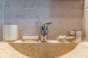 a bathroom counter with a sink and a faucet at La Torretta Suite - Raro Rooms Collection in Ostuni +26 photos