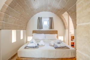 a bedroom with a bed with towels on it at La Torretta Suite - Raro Rooms Collection in Ostuni
