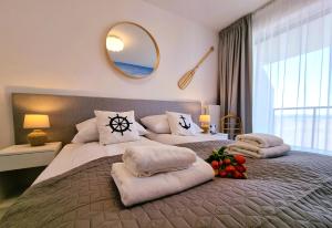 a bedroom with two beds with pillows and a mirror at WESTIN HOUSE Kołobrzeg LUX - 365PAM in Kołobrzeg