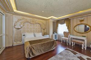 a bedroom with a large bed and a large mirror at Golden Horn Hotel in Istanbul