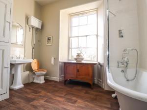 a bathroom with a tub and a toilet and a sink at Windyridge in Settle