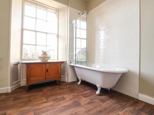 a bathroom with a tub and a window at Windyridge in Settle
