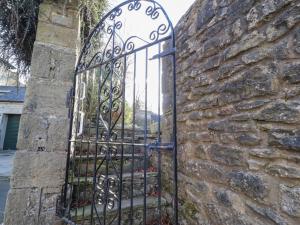 an iron gate in a stone wall at Windyridge in Settle