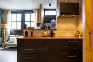 a kitchen with a sink and a stove at Stay and Sea in Harlingen