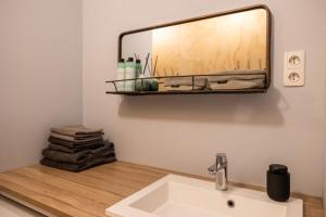 a bathroom with a sink and a mirror on the wall at Stay and Sea in Harlingen