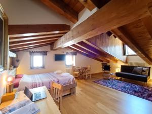a bedroom with a bed and a table in a room at La Maison des myrtilles - Bluchalet in La Thuile