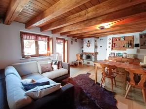 a living room with a couch and a table at La Maison des myrtilles - Bluchalet in La Thuile