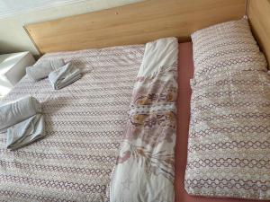 a bed with a comforter and pillows on it at Mellory hotel in Blackpool