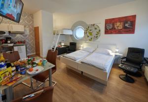a bedroom with a bed and a table with a dining room at Aparthotel Wilma in Bremen