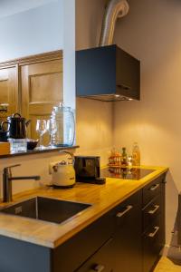 a kitchen with a sink and a counter top at Stay and Sea in Harlingen