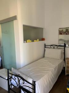 a bed in a room with a mirror on the wall at B&B Medali in Vernole