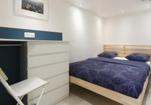 Katil atau katil-katil dalam bilik di Appartement Petits Champs