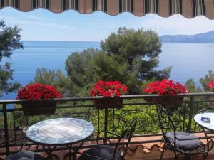 a balcony with tables and chairs and a view of the water at Zia Yaya in Maratea