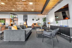 a living room with a couch and a table at Robukta Lodge l Jacuzzi l Sauna l Table Tennis in Tromsø +31 photos