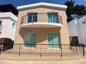 a house with a balcony in front of it at Three Bedroom Casa de Paphos in Paphos City