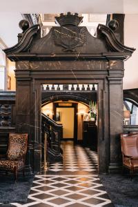 an entrance to a building with a checkered floor at Schlosshotel Hugenpoet in Essen