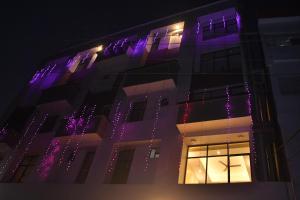 a building with purple lights on the side of it at The Royal Chandra in Samastīpur