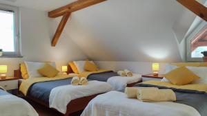a room with four beds with towels on them at Peaceful Family Apartments near Terme Čatež in Čatež ob Savi