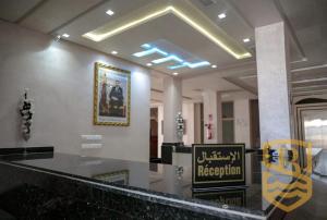 a lobby with a bar with a sign on it at HOTEL BEAUPORT in Laayoune