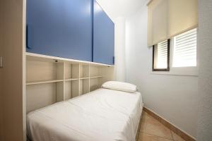 a small bedroom with a bed and a window at APARTAMENTO LUZ DEL SOL in Barbate