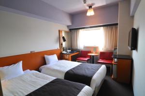 Postel nebo postele na pokoji v ubytování Hotel Listel Shinjuku