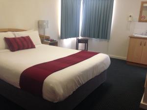 a hotel room with a large bed in it at O'Shea's Royal Hotel in Goondiwindi
